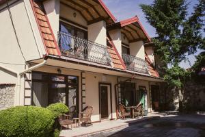 a house with chairs and a balcony at Stara Charshija - Old Bazaar in Bitola