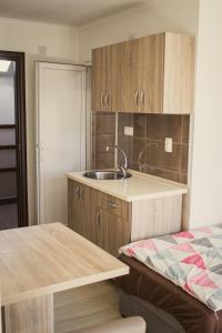 a small kitchen with a sink and a bed at Stara Charshija - Old Bazaar in Bitola +32 photos