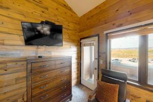 a room with a tv on a wooden wall at Silver Lodge A in Granby