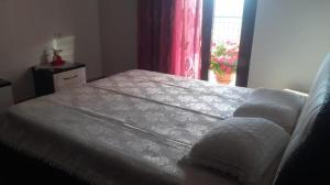 a bed with two pillows on top of it in a bedroom at Villa Alois in Konispol
