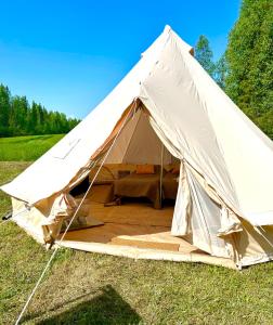 a large white tent in a field of grass at Glamping Arctic Ukuli in Rovaniemi