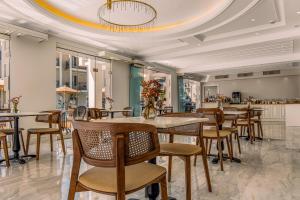 a restaurant with tables and chairs and a ceiling at Royal Nidri Suites in Nydri