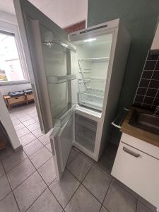 a refrigerator with its door open in a kitchen at Loft im Fabrikstil mit 2 eigenen Schlafzimmern mit Wlan und Parkplatz in Groß-Umstadt +8 photos