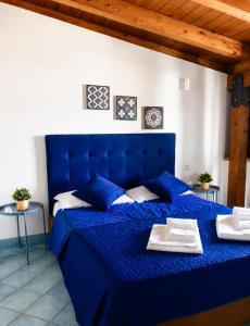 a blue bed with two towels on top of it at Affitti Brevi SCALA DEI TURCHI in Realmonte