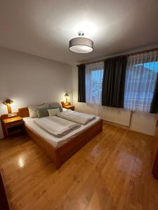 a bedroom with a large bed and a large window at Ferienwohnung Hubenbauer in Seebach