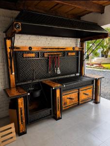 an outdoor kitchen with a sink and wooden cabinets at De Papel Villa in Jankoviči