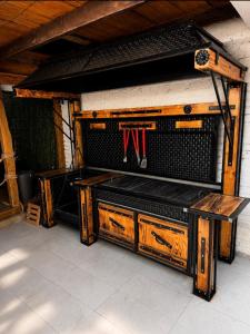 a wooden bench with utensils on top of it at De Papel Villa in Jankoviči