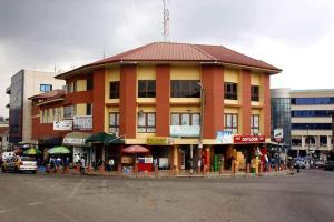 a building on the side of a city street with at O Ansah Plaza Lodge in Kumasi