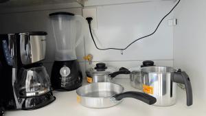 a kitchen counter with a blender and pots and pans at Studio V Ininga in Teresina