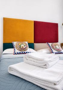 a bedroom with two beds with towels on them at Affitti Brevi SCALA DEI TURCHI in Realmonte