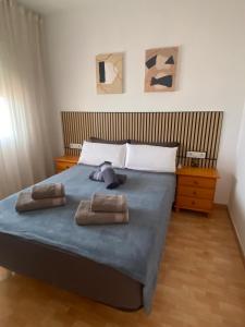 a bedroom with a bed with two towels on it at Vista al Mar in Piles