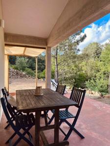 a wooden table and chairs on a porch at Casa da Rigueira in Moreira do Lima