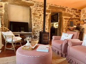 a living room with two couches and a fireplace at Casa da Rigueira in Moreira do Lima