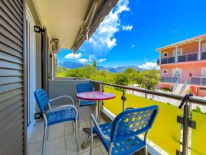 a balcony with a table and chairs and a view at Octopus in Vasiliki