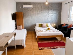 a small room with two beds and a table at Alice's Home in Surčin