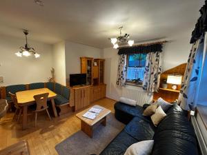 a living room with a couch and a table at Ferienwohnung Hubenbauer in Seebach