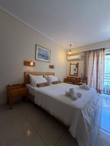 a bedroom with a large bed and a mirror at Paradise Hotel in Kos +19 photos