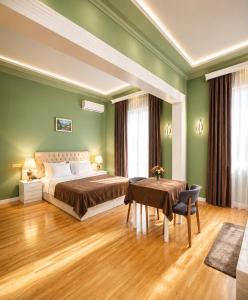 a bedroom with green walls and a bed and a table at White House SPA Hotel in Baku