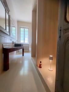 a room with a desk and a lamp on the floor at Casa Negrita in Bra