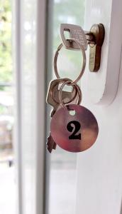 a padlock on a door with the number two at Forest Apartman in Makó