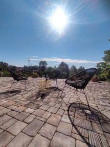 a group of chairs sitting on a stone patio at Casa Negrita in Bra