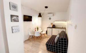 a living room with a couch and a table at Forest Apartman in Makó +11 photos