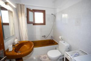 a bathroom with a sink and a toilet and a tub at Anemoessa in Ammoudia +17 photos