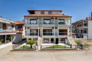 a large white building with stairs in front of it at Villa N&D in Ierissos