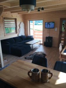 a living room with a couch and a table at Domek Niedźwiedź in Groń