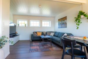a living room with a couch and a table at Sigridhuset in Moskenes +87 photos