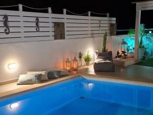 a swimming pool in a backyard at night at Secret Paradise in Koutsounari
