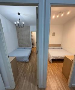 a room with two beds and a mirror at Badalona Old Town Dalt de la Vila in Badalona