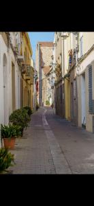 an empty street in a city with buildings at Badalona Old Town Dalt de la Vila in Badalona