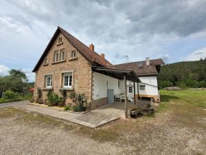 a brick house with a porch at Lauberhof in Trippstadt
