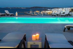 a swimming pool with a view of a city at Piperi On The Rocks in Naousa
