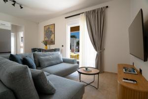 a living room with a couch and a table at Marevia in Nopíyia