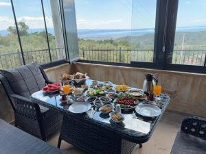 a table with food on top of a balcony at Helios Kaz Dağları in Edremit