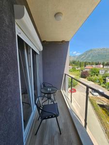 a balcony with a table and a view of a street at Azure Coast in Bar