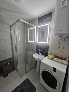 a bathroom with a shower and a washing machine at Azure Coast in Bar +10 photos