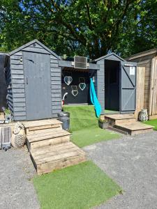 a play house with a pair of sunglasses in the yard at Route 47 Glamping Bell Tents in Cross Hands