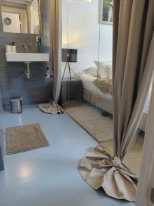 a room with a mirror and a bed in it at Logies De Lelie in Antwerp