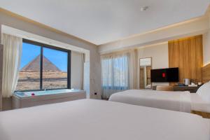 a hotel room with a view of the pyramids at The Stay Pyramids Inn in Cairo