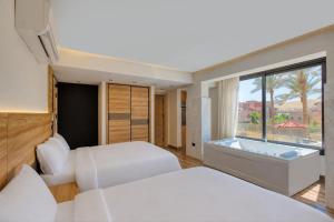 a hotel room with two beds and a window at The Stay Pyramids Inn in Cairo