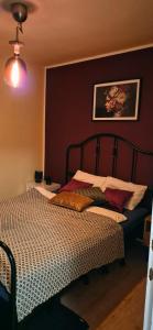 a bedroom with a bed and a painting on the wall at See Love 2 in Zagreb +3 photos