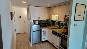 a kitchen with white cabinets and a blue refrigerator at Edgewater House in Rehoboth Beach