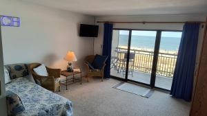 a bedroom with a room with a view of the beach at Edgewater House in Rehoboth Beach