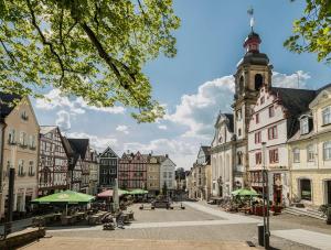 a city street with buildings and a clock tower at Hirschquartier in Hachenburg