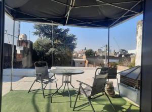 a patio with a table and chairs under a tent at LodelaAbuela 2 in Ciudadela