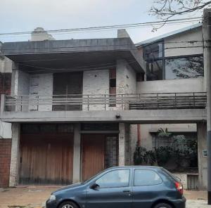 a blue car parked in front of a house at LodelaAbuela 2 in Ciudadela +3 photos