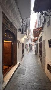 an alley way with an entrance to a building at Riad Arous Chamel in Tangier